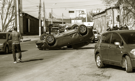 ODESSA, UKRAINE March 19, 2019: after car accident, broken car rolled over and lay down on roof on road that other cars drive. Concept of careless driving, breaking rules and speeding on roadのeditorial素材