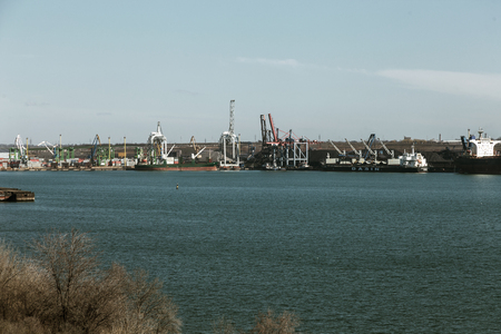 Odessa, Ukraine, South-March 20, 2019: Aerial view of panoramic seaport warehouse and container ship, crane vessel is working to deliver containers. South Sea Industrial Port, Port Factoryのeditorial素材