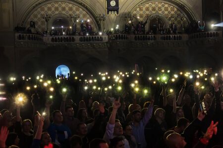 ODESSA, UKRAINE - March 23, 2019: viewers in auditorium of concert hall emotionally meet their favorite performers. Audience in theater hall. Viewers like performance on stageのeditorial素材