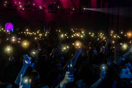 ODESSA, UKRAINE - March 23, 2019: viewers in auditorium of concert hall emotionally meet their favorite performers. Audience in theater hall. Viewers like performance on stageのeditorial素材