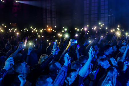 ODESSA, UKRAINE - March 23, 2019: viewers in auditorium of concert hall emotionally meet their favorite performers. Audience in theater hall. Viewers like performance on stageのeditorial素材
