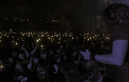 ODESSA, UKRAINE - March 23, 2019: viewers in auditorium of concert hall emotionally meet their...