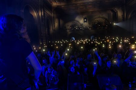 ODESSA, UKRAINE - March 23, 2019: viewers in auditorium of concert hall emotionally meet their favorite performers. Audience in theater hall. Viewers like performance on stageのeditorial素材