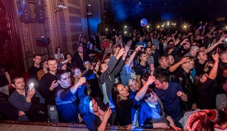 ODESSA, UKRAINE - March 23, 2019: viewers in auditorium of concert hall emotionally meet their favorite performers. Audience in theater hall. Viewers like performance on stageのeditorial素材