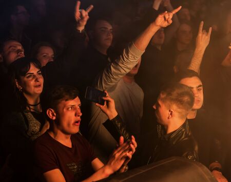 ODESSA, UKRAINE - March 23, 2019: viewers in auditorium of concert hall emotionally meet their favorite performers. Audience in theater hall. Viewers like performance on stageのeditorial素材