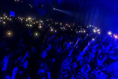 ODESSA, UKRAINE - March 23, 2019: viewers in auditorium of concert hall emotionally meet their favorite performers. Audience in theater hall. Viewers like performance on stageのeditorial素材