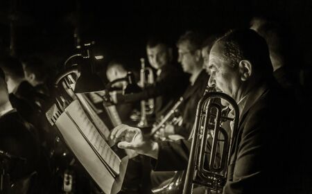 ODESSA, UKRAINE - March 23, 2019: Symphony orchestra concert on theater stage. Musicians of State Symphony Orchestra, instruments of symphony orchestra on stage. Score, sheet music during concertのeditorial素材
