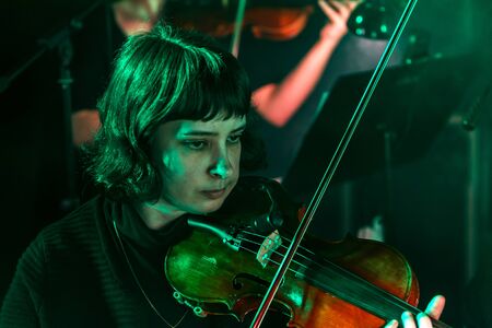 ODESSA, UKRAINE - March 23, 2019: Symphony orchestra concert on theater stage. Musicians of State Symphony Orchestra, instruments of symphony orchestra on stage. Score, sheet music during concertのeditorial素材