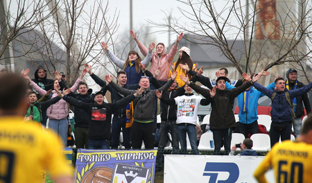 ODESSA, UKRAINE - April 13, 2019: large crowd of spectators in the stands of the stadium during the match of their favorite clubs. Crowds of enthusiastic fans in stands of a small provincial stadiumのeditorial素材