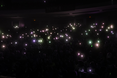 Odessa, Ukraine - April 12, 2019: Crowd of spectators at rock concert ALEKSEEV during music show. Crowds of happy people enjoy rock concert, raise their hands and clap their hands, audience on podiumのeditorial素材