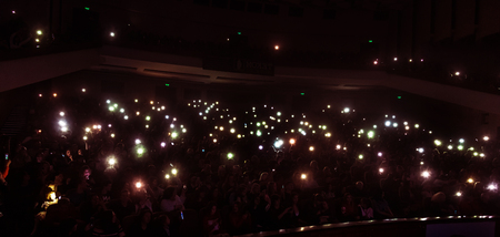 Odessa, Ukraine - April 12, 2019: Crowd of spectators at rock concert ALEKSEEV during music show. Crowds of happy people enjoy rock concert, raise their hands and clap their hands, audience on podiumのeditorial素材