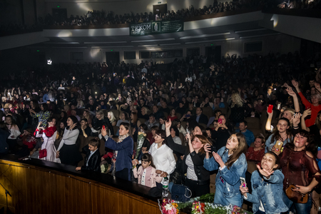 Odessa, Ukraine - April 12, 2019: Crowd of spectators at rock concert ALEKSEEV during music show. Crowds of happy people enjoy rock concert, raise their hands and clap their hands, audience on podiumのeditorial素材