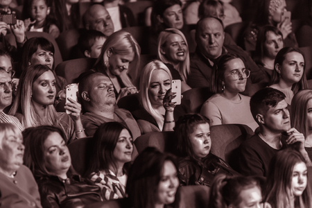 Odessa, Ukraine - April 12, 2019: Crowd of spectators at rock concert ALEKSEEV during music show. Crowds of happy people enjoy rock concert, raise their hands and clap their hands, audience on podiumのeditorial素材