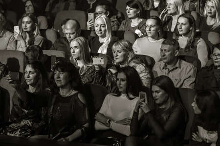 Odessa, Ukraine - April 12, 2019: Crowd of spectators at rock concert ALEKSEEV during music show. Crowds of happy people enjoy rock concert, raise their hands and clap their hands, audience on podiumのeditorial素材