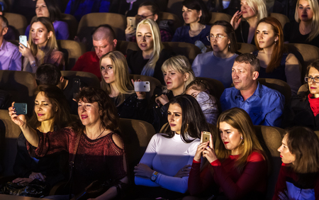 Odessa, Ukraine - April 12, 2019: Crowd of spectators at rock concert ALEKSEEV during music show. Crowds of happy people enjoy rock concert, raise their hands and clap their hands, audience on podiumのeditorial素材