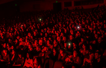 Odessa, Ukraine - April 12, 2019: Crowd of spectators at rock concert ALEKSEEV during music show. Crowds of happy people enjoy rock concert, raise their hands and clap their hands, audience on podiumのeditorial素材