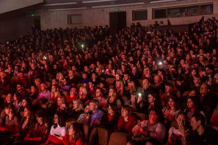 Odessa, Ukraine - April 12, 2019: Crowd of spectators at rock concert ALEKSEEV during music show. Crowds of happy people enjoy rock concert, raise their hands and clap their hands, audience on podiumのeditorial素材