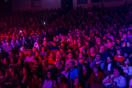 Odessa, Ukraine - April 12, 2019: Crowd of spectators at rock concert ALEKSEEV during music show. Crowds of happy people enjoy rock concert, raise their hands and clap their hands, audience on podiumのeditorial素材