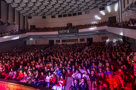 Odessa, Ukraine - April 12, 2019: Crowd of spectators at rock concert ALEKSEEV during music show. Crowds of happy people enjoy rock concert, raise their hands and clap their hands, audience on podiumのeditorial素材