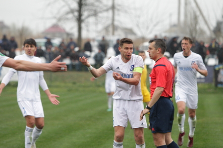 ODESSA, UKRAINE - April 13, 2019: Football match first league of FC Balkans-Odessa and Metalist-Kharkov. Dynamic fragments of football match. Fight for ball, playing football on green field of stadiumのeditorial素材