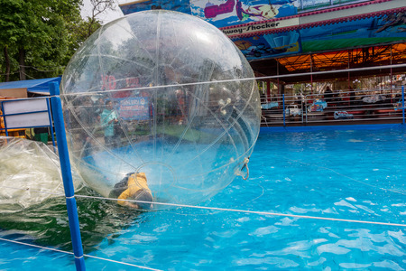 Odessa, Ukraine - May 6, 2019. Little children in an inflatable balloon, having fun on the water. The ball in the water - fascinating summer attractions for children. Water zorbingのeditorial素材