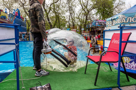 Odessa, Ukraine - May 6, 2019. Little children in an inflatable balloon, having fun on the water. The ball in the water - fascinating summer attractions for children. Water zorbingのeditorial素材