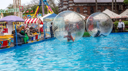 Odessa, Ukraine - May 6, 2019. Little children in an inflatable balloon, having fun on the water. The ball in the water - fascinating summer attractions for children. Water zorbingのeditorial素材