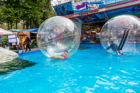 Odessa, Ukraine - May 6, 2019. Little children in an inflatable balloon, having fun on the water. The ball in the water - fascinating summer attractions for children. Water zorbingのeditorial素材