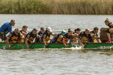 Odessa, Ukraine - June 2, 2019: Dragon Boat Racing during Dragon Boat Festival, DragBoat Racing is popular traditional Chinese water sport. Dragboat on river. People rowing oars in summer raceのeditorial素材