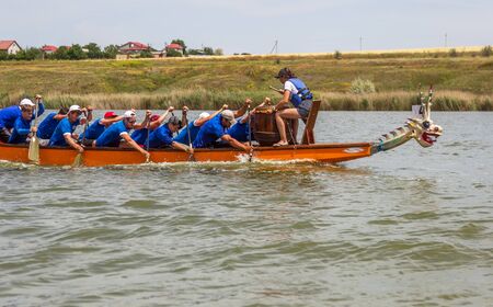 Odessa, Ukraine - June 2, 2019: Dragon Boat Racing during Dragon Boat Festival, DragBoat Racing is popular traditional Chinese water sport. Dragboat on river. People rowing oars in summer raceのeditorial素材
