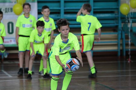 ODESSA, UKRAINE - MAY 18, 2019: Young children play rugby during final games of championship in hall. Children's sport. Children play rugby 5. Fight for victory of children in rugbyのeditorial素材