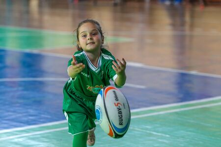 ODESSA, UKRAINE - MAY 18, 2019: Young children play rugby during final games of championship in hall. Children's sport. Children play rugby 5. Fight for victory of children in rugbyのeditorial素材
