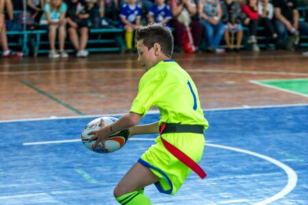 ODESSA, UKRAINE - MAY 18, 2019: Young children play rugby during final games of championship in hall. Children's sport. Children play rugby 5. Fight for victory of children in rugbyのeditorial素材