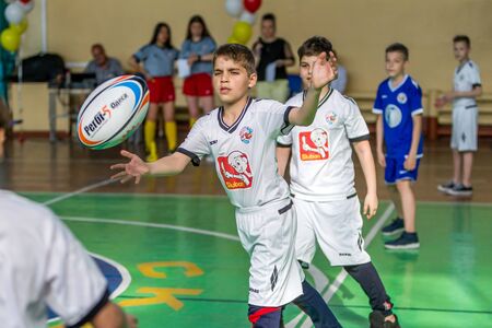 ODESSA, UKRAINE - MAY 18, 2019: Young children play rugby during final games of championship in hall. Children's sport. Children play rugby 5. Fight for victory of children in rugbyのeditorial素材