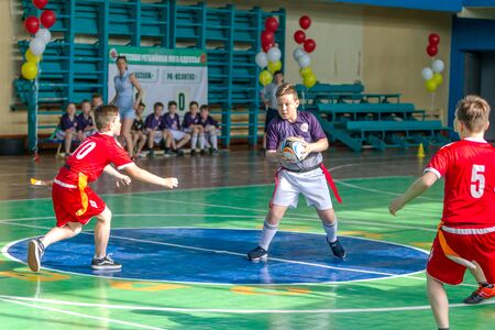 ODESSA, UKRAINE - MAY 18, 2019: Young children play rugby during final games of championship in hall. Children's sport. Children play rugby 5. Fight for victory of children in rugbyのeditorial素材