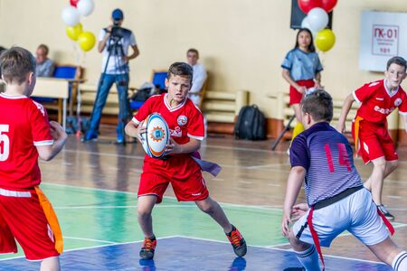 ODESSA, UKRAINE - MAY 18, 2019: Young children play rugby during final games of championship in...