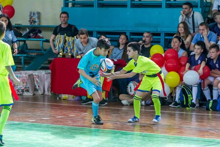ODESSA, UKRAINE - MAY 18, 2019: Young children play rugby during final games of championship in hall. Children's sport. Children play rugby 5. Fight for victory of children in rugbyのeditorial素材