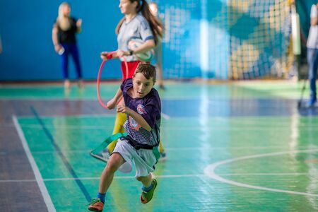 ODESSA, UKRAINE - MAY 18, 2019: Young children play rugby during final games of championship in hall. Children's sport. Children play rugby 5. Fight for victory of children in rugbyのeditorial素材