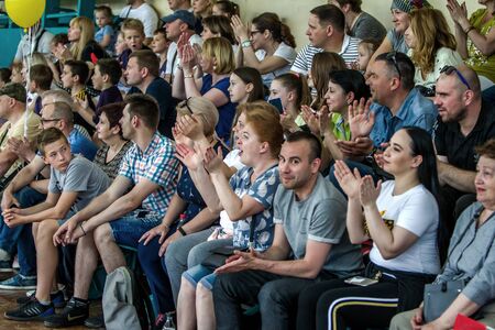 ODESSA, UKRAINE - May 18, 2019. Spectators, fans in stands of gym are emotionally supported by team...