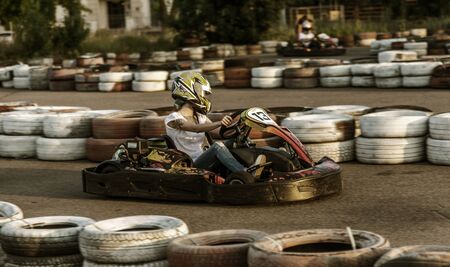 ODESSA, UKRAINE - June 19, 2019: karting. Racers on races on special safe high-speed tracks limited by car tires. Attraction High-speed ride in carts. Sport karting entertainmentのeditorial素材