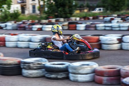 ODESSA, UKRAINE - June 19, 2019: karting. Racers on races on special safe high-speed tracks limited by car tires. Attraction High-speed ride in carts. Sport karting entertainmentのeditorial素材