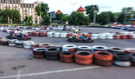 ODESSA, UKRAINE - June 19, 2019: karting. Racers on races on special safe high-speed tracks limited by car tires. Attraction High-speed ride in carts. Sport karting entertainmentのeditorial素材