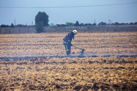 Raging steppe fires. On field after harvesting grain harness straw and straw. Ecological catastrophy. Fire and smoke destroy all life. Firefighters extinguish the Great Fire. Lot of smokeの写真素材