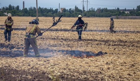 Raging steppe fires. On field after harvesting grain harness straw and straw. Ecological catastrophy. Fire and smoke destroy all life. Firefighters extinguish the Great Fire. Lot of smokeのeditorial素材