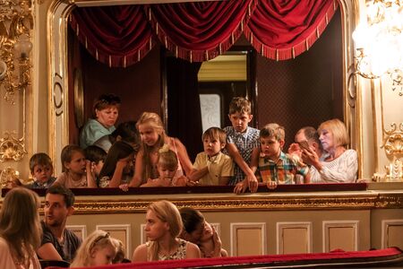 Odessa, Ukraine - CIRCA 2019: selective focus. Spectators children in theater during popular children's play. Children's Delight audience. Concert audience in motion. Children's spectators in theaterのeditorial素材