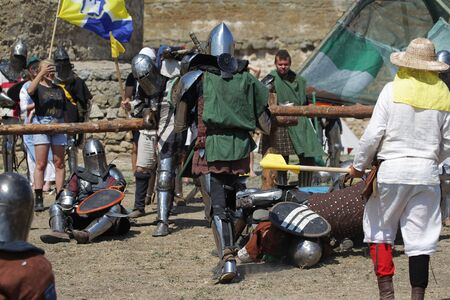 ODESSA, UKRAINE - JULY 20, 2019: Battle of the Knights with medieval weapons at the medieval performance. Knights fight on the field during the battle tournament of the festival of medieval cultureのeditorial素材