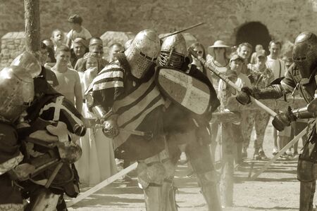 ODESSA, UKRAINE - JULY 20, 2019: Battle of the Knights with medieval weapons at the medieval performance. Knights fight on the field during the battle tournament of the festival of medieval cultureのeditorial素材