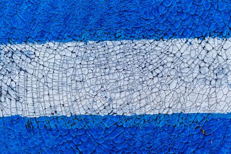 Cracked wall with old layers of paint in an abandoned house. Abstract peeling paint. Dirty building surface with shattered texture. Fragment of facade of building. Old wall fragment graffiti crackの写真素材
