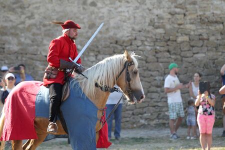 ODESSA, UKRAINE - JULY 20, 2019: Equestrian traditional competitions at knight's festival in fortress Akkerman Belgorod-Dniester. Horseman with spear, sword on horse. Motion blurred backgroundのeditorial素材