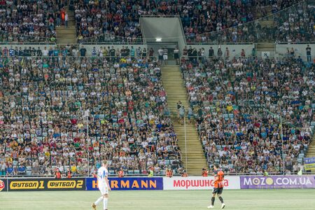 ODESSA UKRAINE - July 28, 2019: spectators at stadium. Crowds of fans in stands of football stadium during match Shakhtar (Donetsk) -Dynamo (Kiev). Grandstand with fans. Stands with football fansのeditorial素材